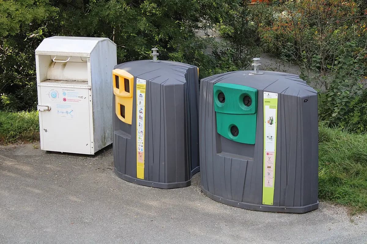 Recycling containers for paper, packaging and glass at the side of a road